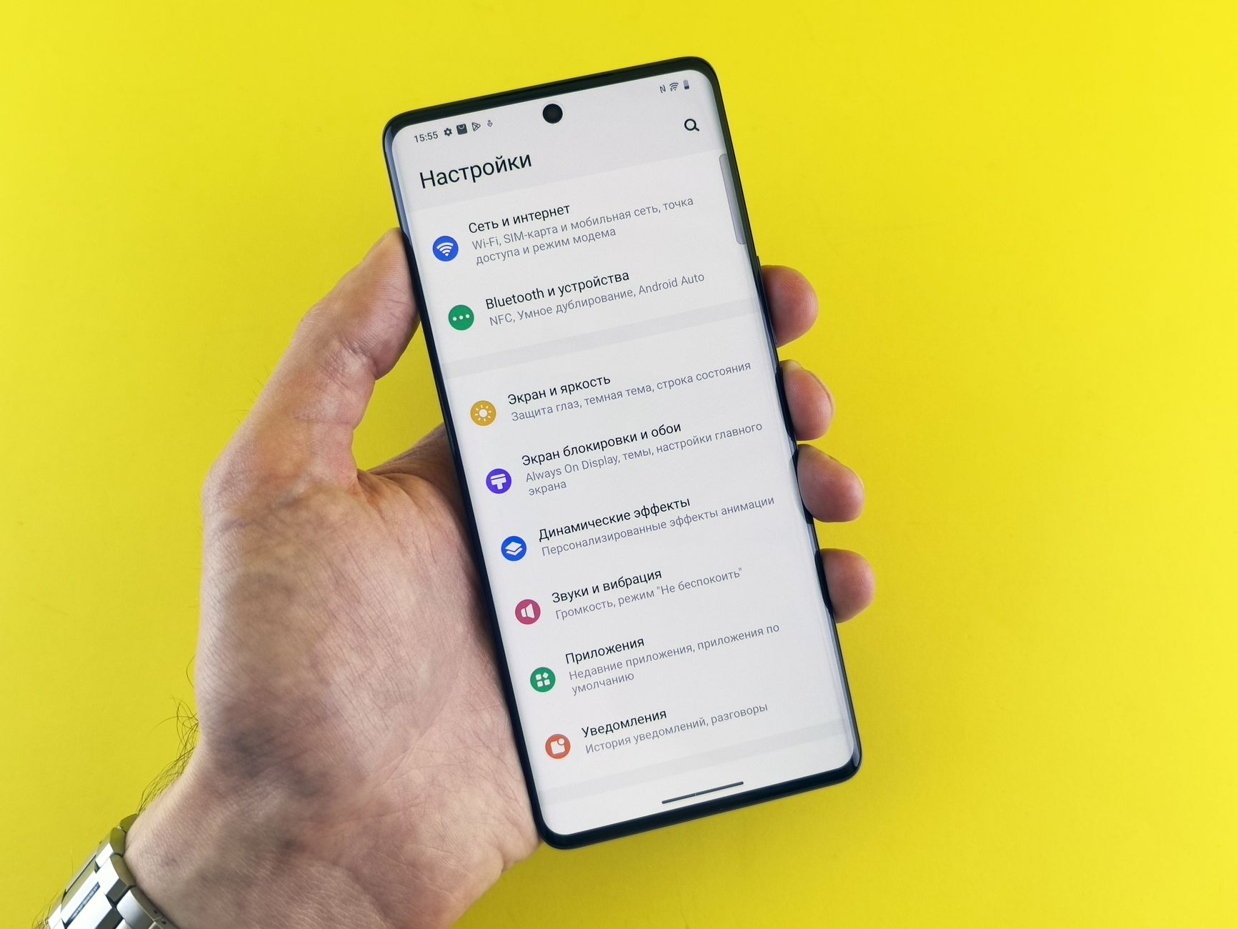 Senior hands hold a smartphone with the Android storage settings menu open.