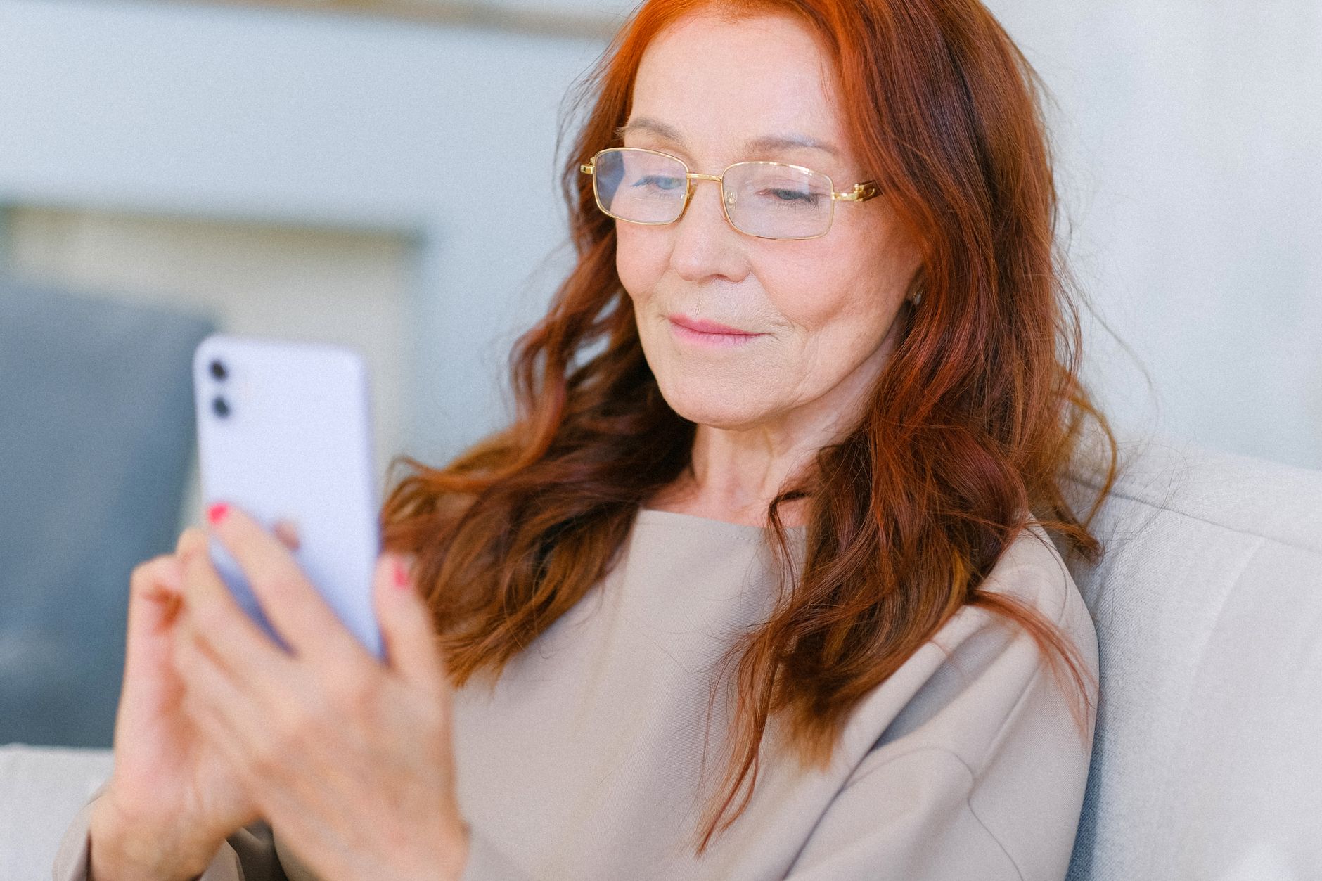 an older adult holding an iPhone and looking at the screen to set up Face ID